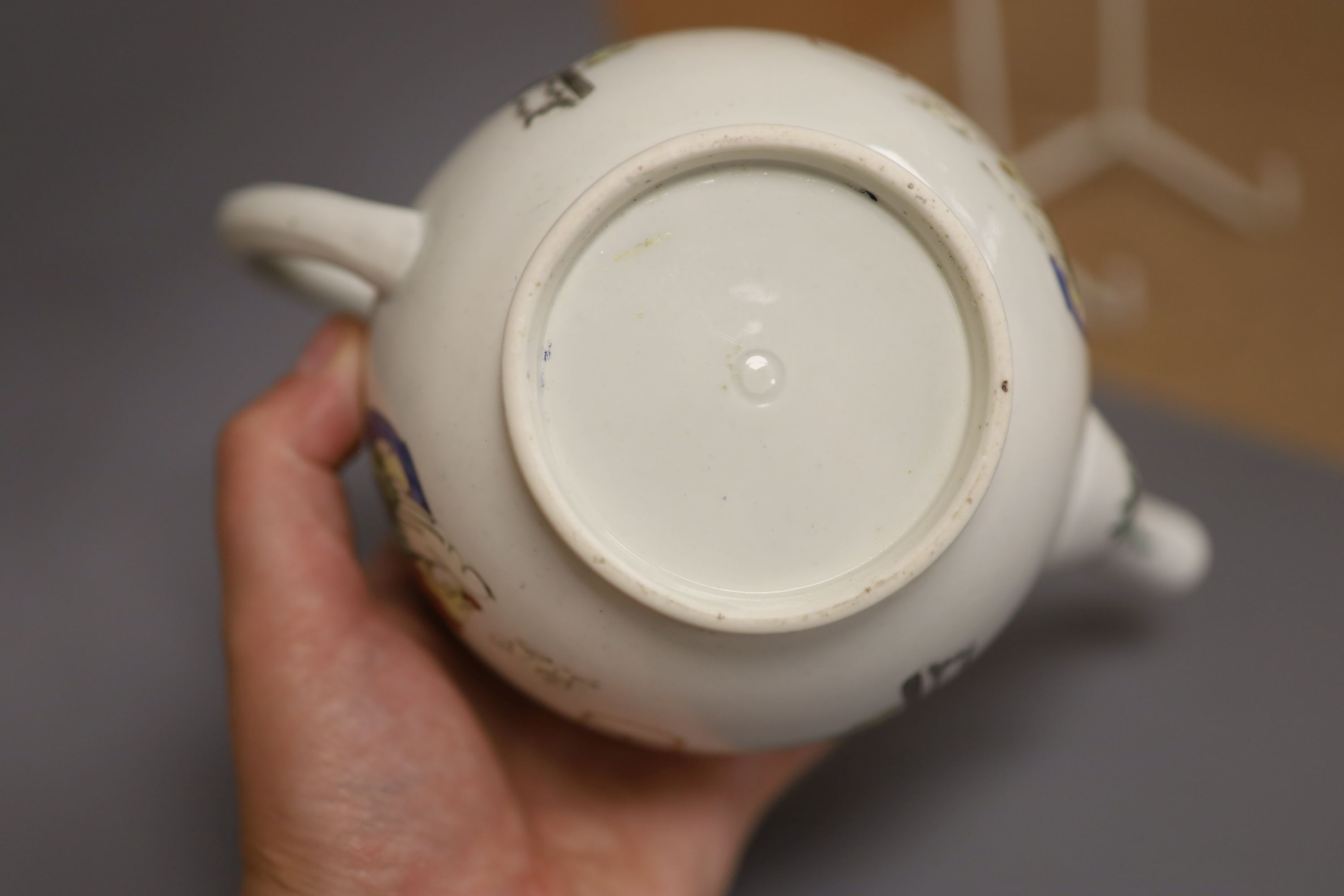 A Worcester teapot and cover painted with Oriental figures in various pursuits, c.1770, height 13cm